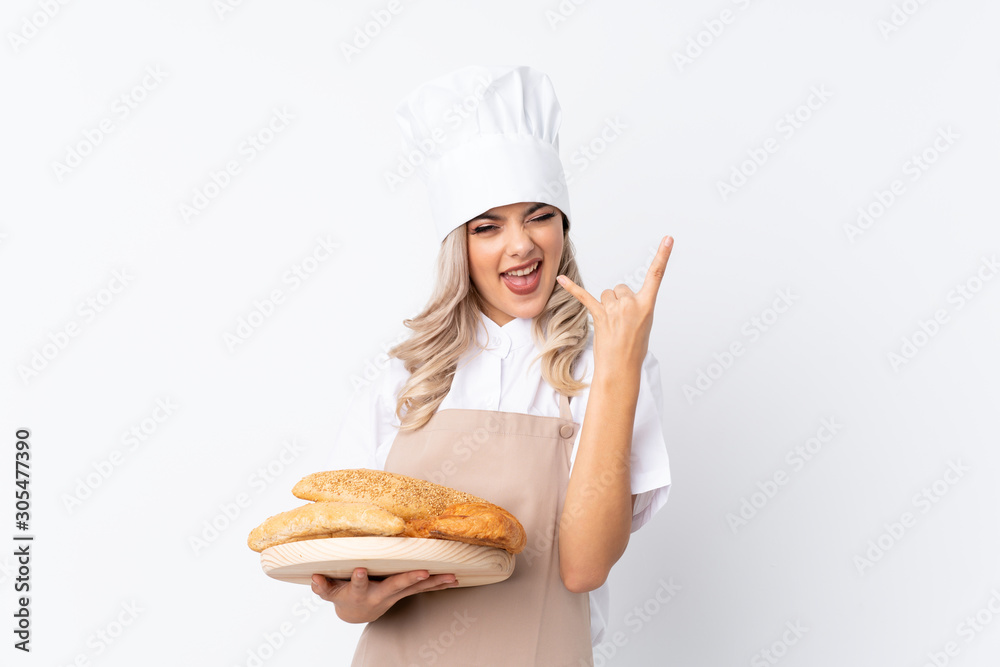 Teenager girl in chef uniform. Female baker holding a table with several breads over isolated white background unhappy and frustrated with something Teenager girl in chef uniform. Female baker holding a table with several breads over isolated white background unhappy and frustrated with something