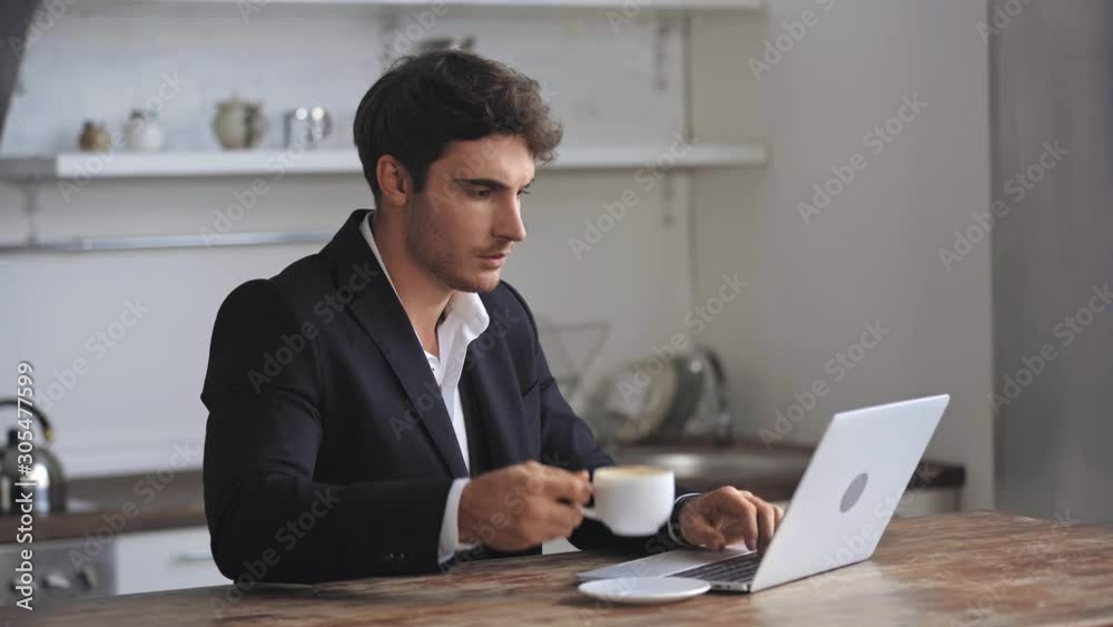 businessman using laptop and drinking coffee businessman using laptop and drinking coffee