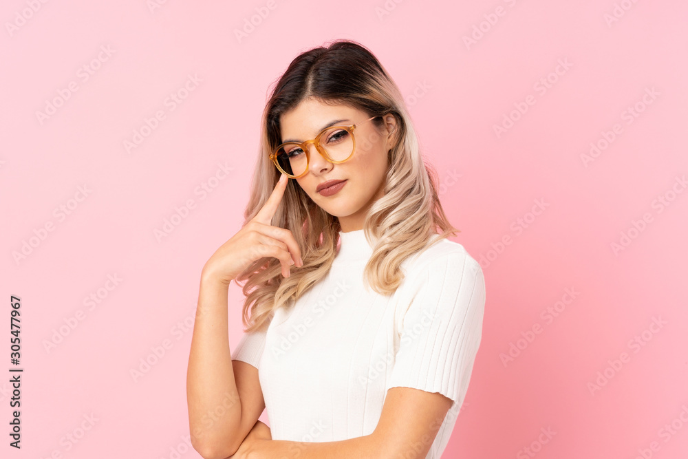 Teenager girl over isolated pink background with glasses Teenager girl over isolated pink background with glasses