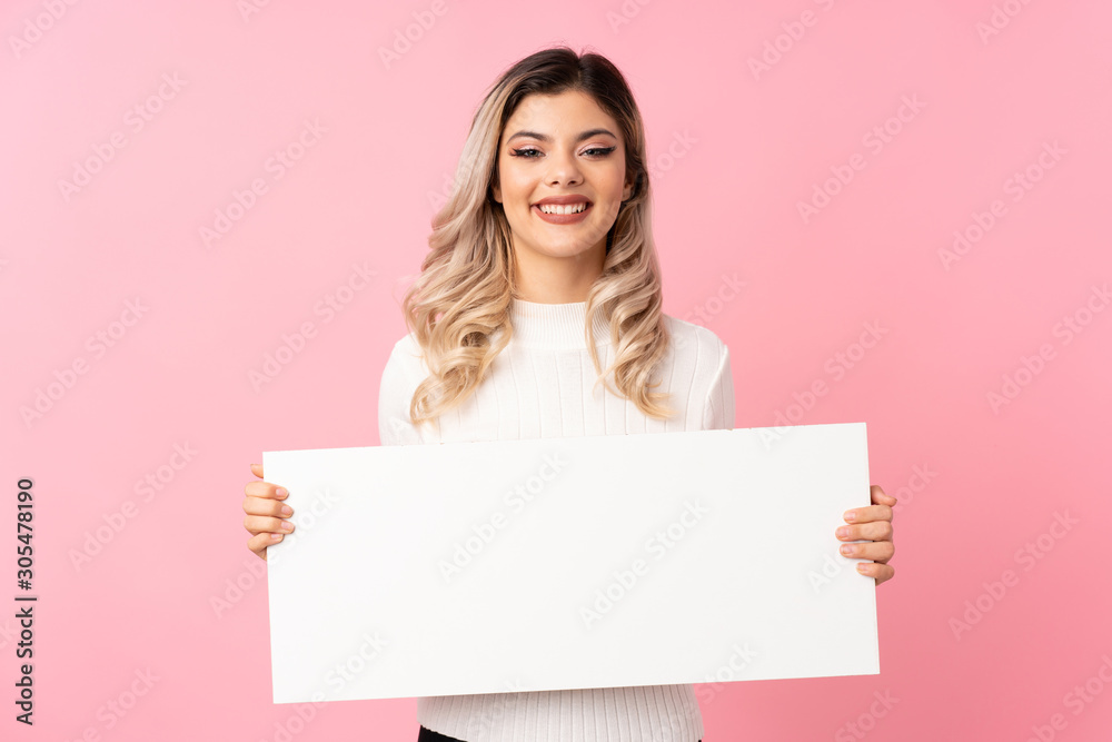 Teenager girl over isolated pink background holding an empty white placard for insert a concept Teenager girl over isolated pink background holding an empty white placard for insert a concept