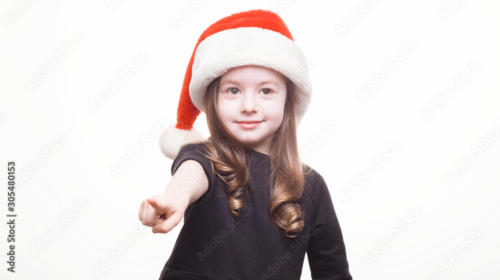 Happy girl in santa hat on white background. Funny young child waiting for christmas, new year and presents. holiday, sale concept with place for text Happy girl in santa hat on white background. Funny young child waiting for christmas, new year and presents. holiday, sale concept with place for text