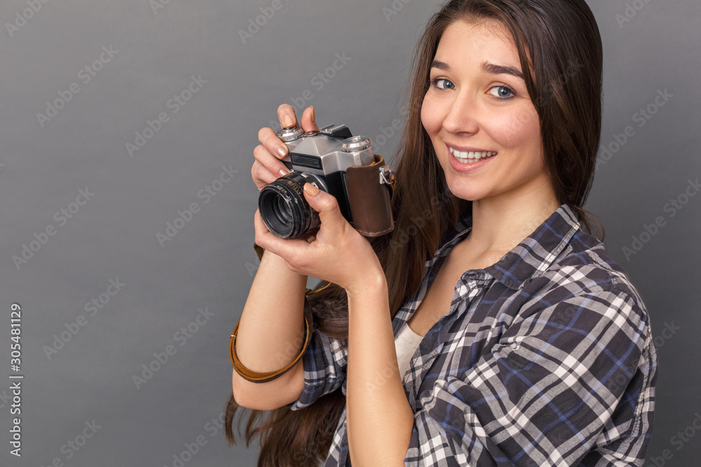 Photography Hobby. Young woman standing studio isolated on grey taking photos with film camera smiling happy close-up Photography Hobby. Young woman standing studio isolated on grey taking photos with film camera smiling happy close-up