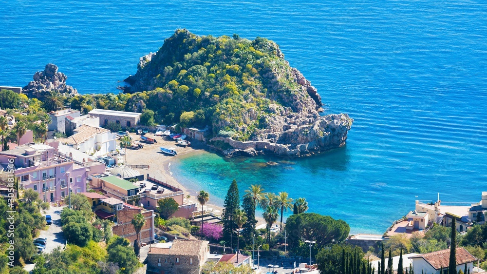 Clear blue sea, comfortable hotels and beach near Isola Bella in Taormina, Sicily, Italy