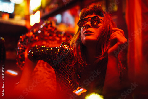 Photography Woman in sparkly dress and reflective sunglasses looking up