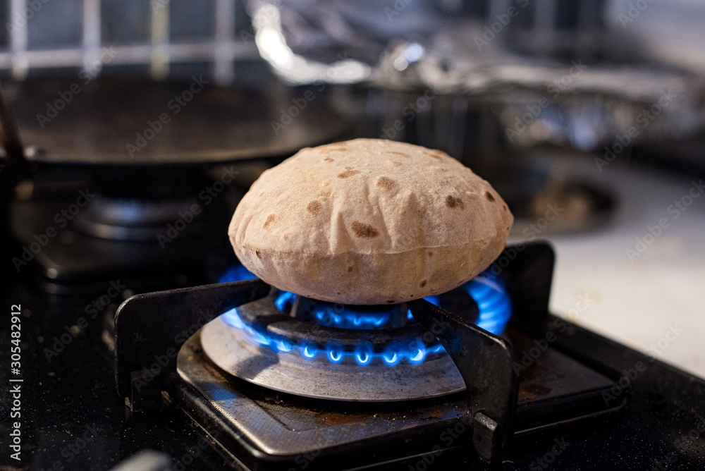 Cooking roti on a gas stove Stock Photo Adobe Stock