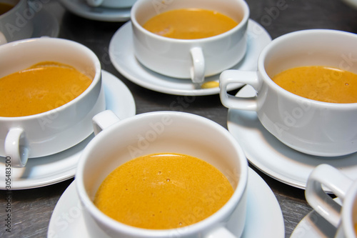  pumpkin soup in white cup gourmet