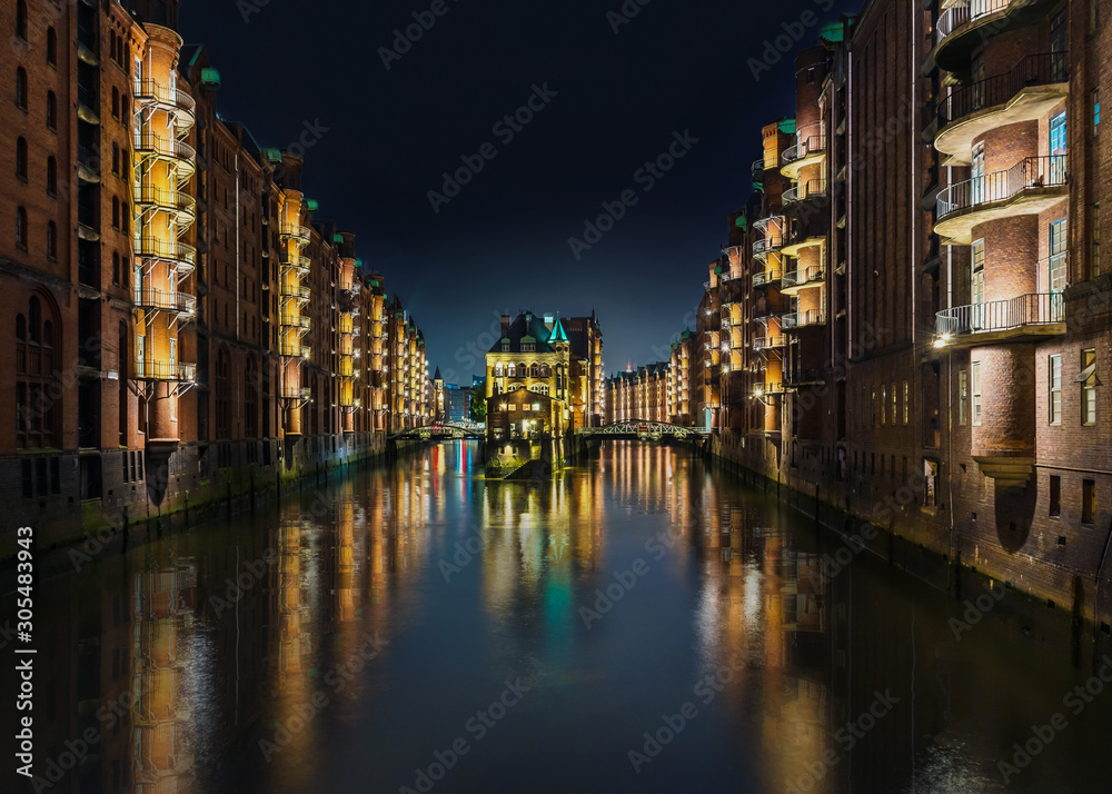 long exposure shot of canal in old warehouse district Speicherstadt in Hamburg, Germany at night