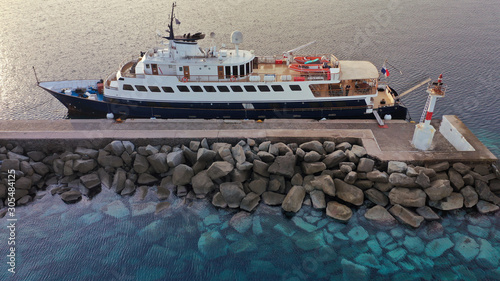Fotografi Aerial drone photo of yacht docked in old port of Mykonos island at sunset, Cycl