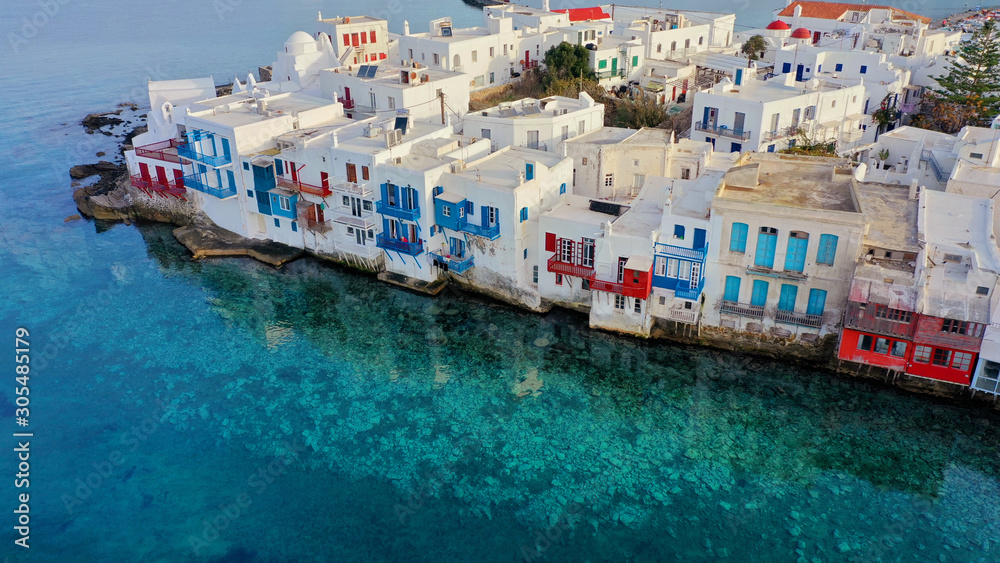 Aerial panoramic view of world famous whitewashed little Venice picturesque settlement in main village of Mykonos island with beautiful deep blue sky and clouds, Cyclades, Greece