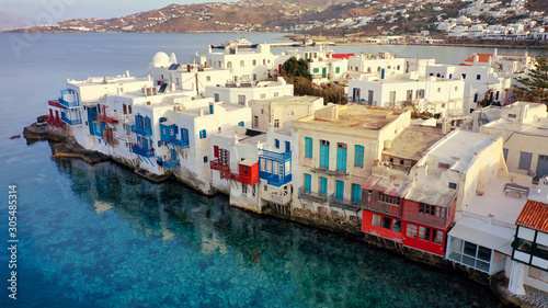 Aerial panoramic view of world famous whitewashed little Venice picturesque settlement in main village of Mykonos island with beautiful deep blue sky and clouds, Cyclades, Greece