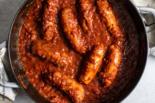 Sausages and tomato sauce in saucepan