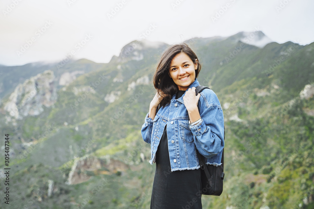 Happy smiling woman with backpack on in the mountains. Travel and lifestyle concept Happy smiling woman with backpack on in the mountains. Travel and lifestyle concept