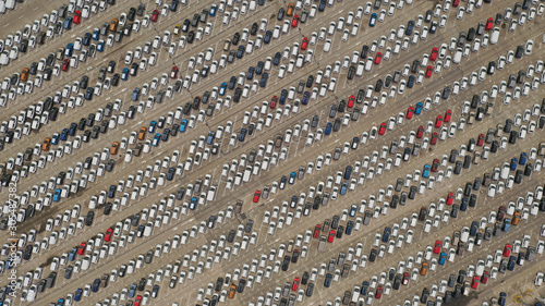 Aerial view of colourful cars abstractly parked ready to sell in Malaga Port, Spain