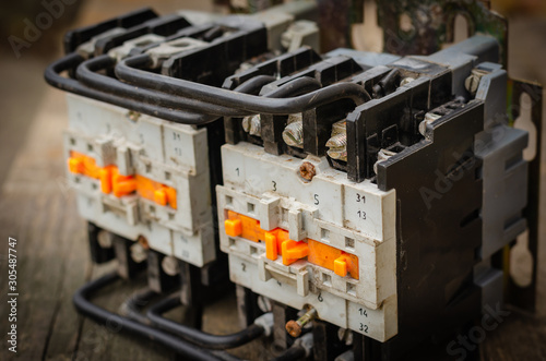 Close-up of a used electric starter (magnetic starter). An electromagnetic device for smoothly starting high-power electric motors. Side view. Selective focus.