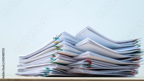 Stack overload document report paper with colorful paperclip on white background, business concept footage paperless used – 4K Stop motion.