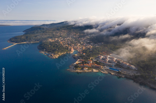 Aerial view above the clouds of Veli Lo?inj cityscape, Croatia. photo