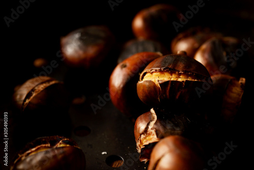 closeup of roasted chestnuts in a pan 