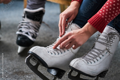 Young couple preparing to a skating