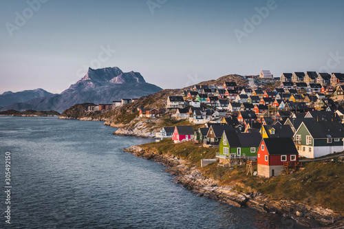 Nuuk capital of Greenland with Beautiful small colorful houses in myggedalen during Sunset Sunrise Midnight Sun. Sermitsiaq Mountain in Background. Blue and pink Sky. photo