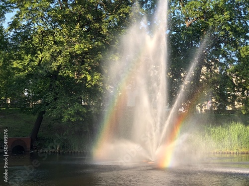 fountain in the park with rainbow