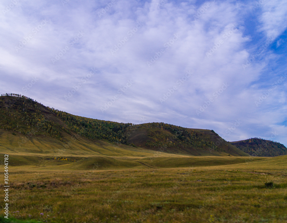 The clouds. Sky. Hills. Steppe.