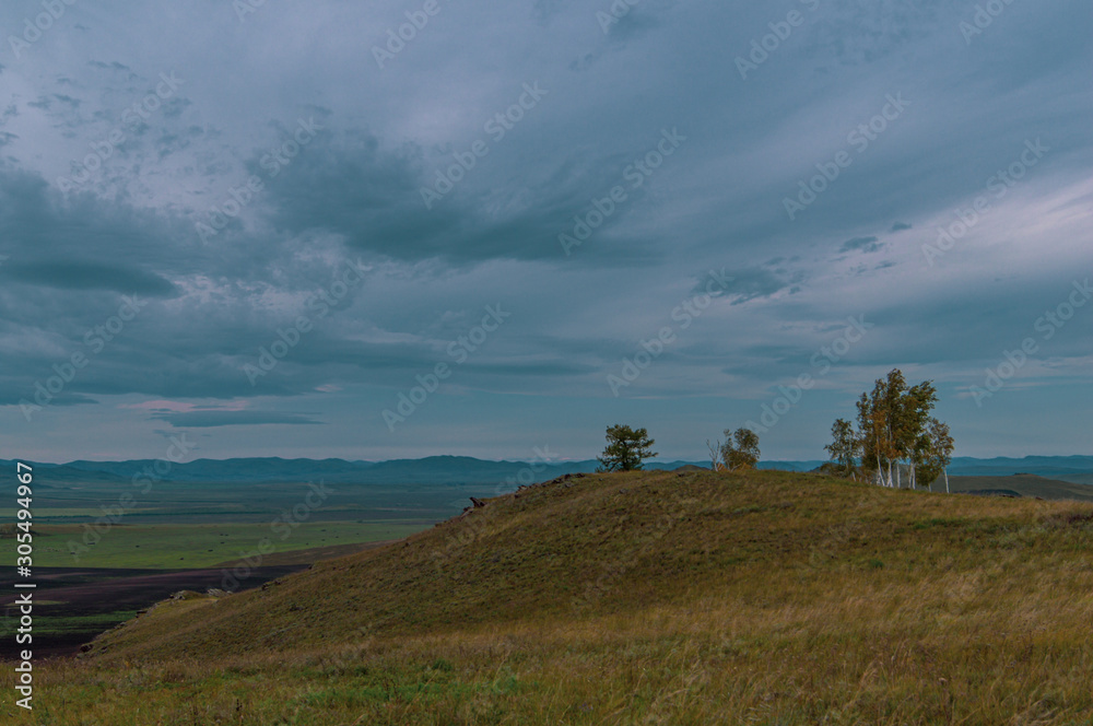 Hills. Sky. The clouds. The trees. Steppe
