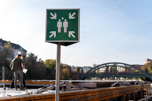 Meetingpoint sign in front of a lovely bridge (shallow depth of field) photo