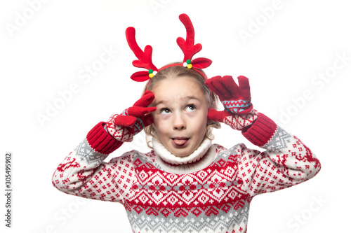 Cute young girl wearing deer horns. New year concept.