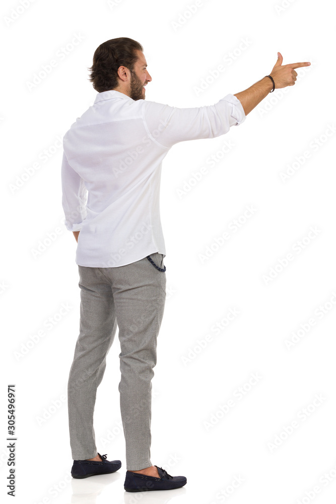 Young Man Is Aiming With His Index Finger And Looking Away Young Man Is Aiming With His Index Finger And Looking Away