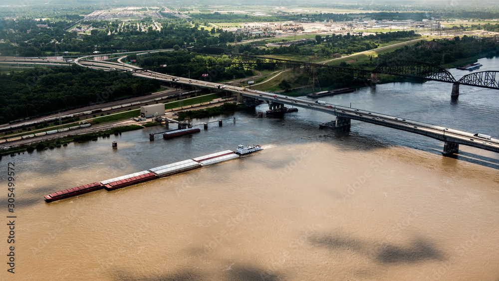 A barge transports freight down the Mississippi River