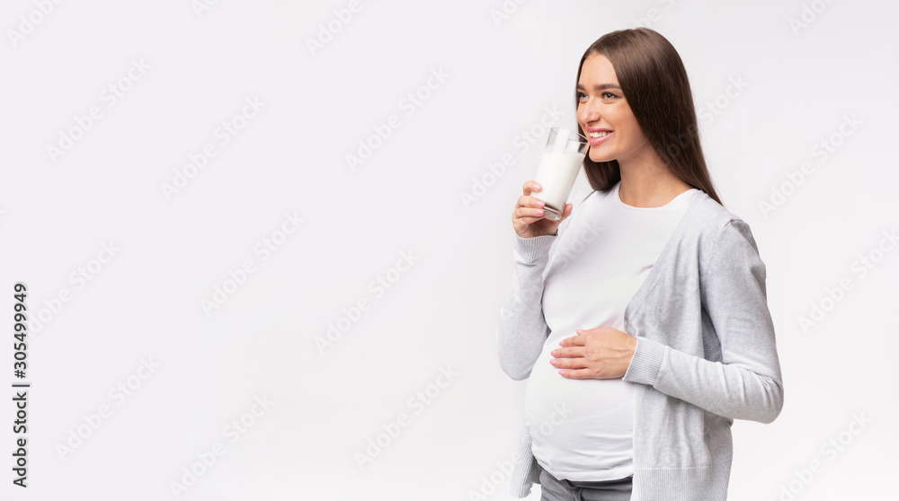 Happy Pregnant Girl Drinking Milk On Gray Studio Background, Panorama