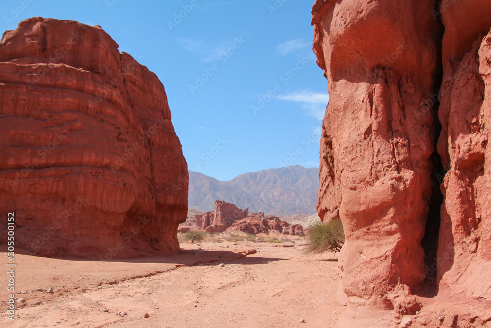 A road crosses the red rocks of La Quebrada de las Conchas, Argentina