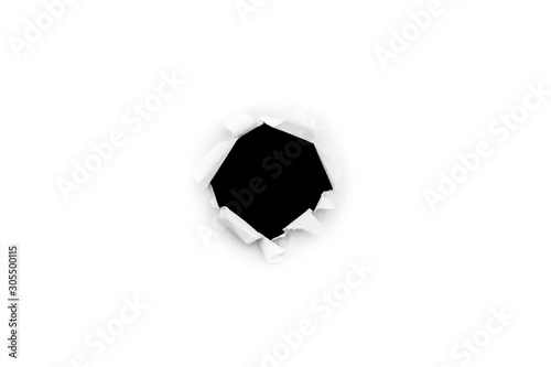 A round hole in white paper with torn edges isolated on a white background with a black isolated background inside.