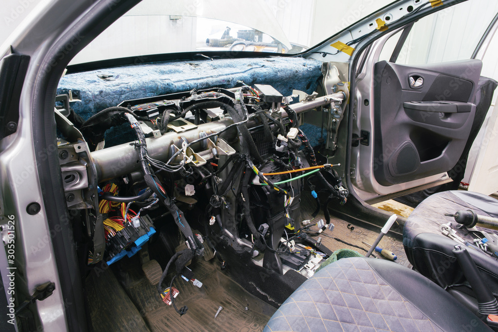 Disassembled interior of the car, without the front panel and protruding wires.