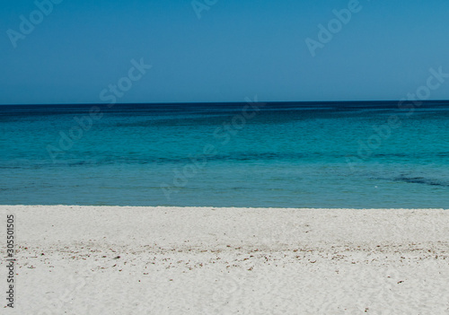 white sand beach blue sea and sky