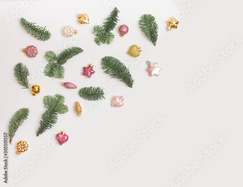 Christmas or New Year background: fir tree branches, glass balls, decoration and cones on a white background
