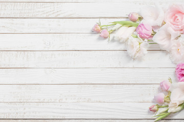 pink and white flowers on white wooden background