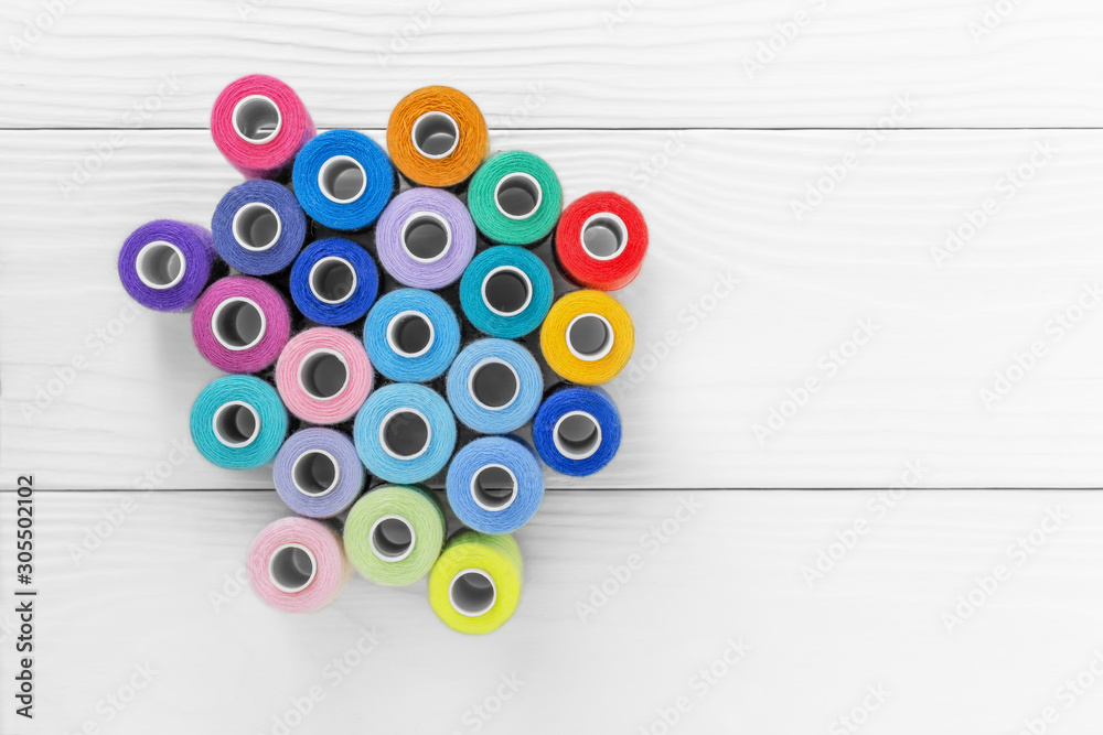 Colored threads on spools on a white background, Colored threads on spools on a white background,