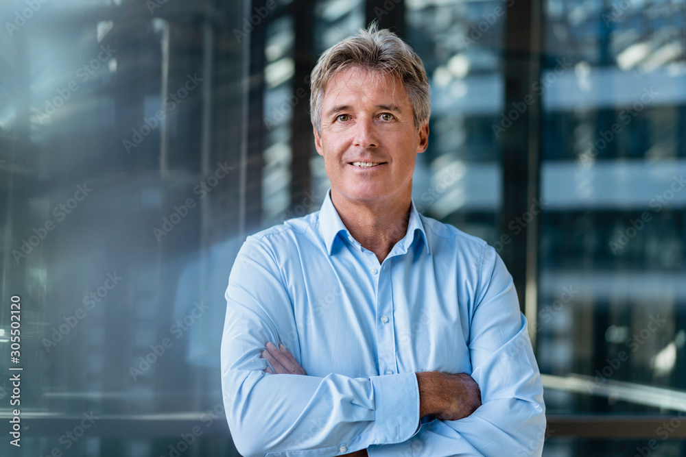 Portrait of confident mature businessman outside an office building Portrait of confident mature businessman outside an office building