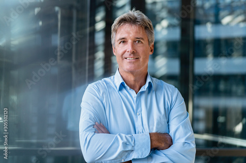 Portrait of confident mature businessman outside an office building