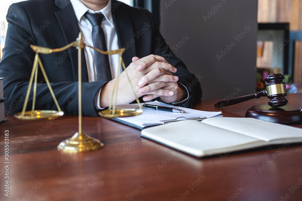 Professional male lawyer or counselor working with legal case document contract in office, law and justice, attorney, lawsuit concept Professional male lawyer or counselor working with legal case document contract in office, law and justice, attorney, lawsuit concept