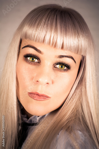 Portrait of a beautiful woman with long blond hair. Shooting in the Studio.