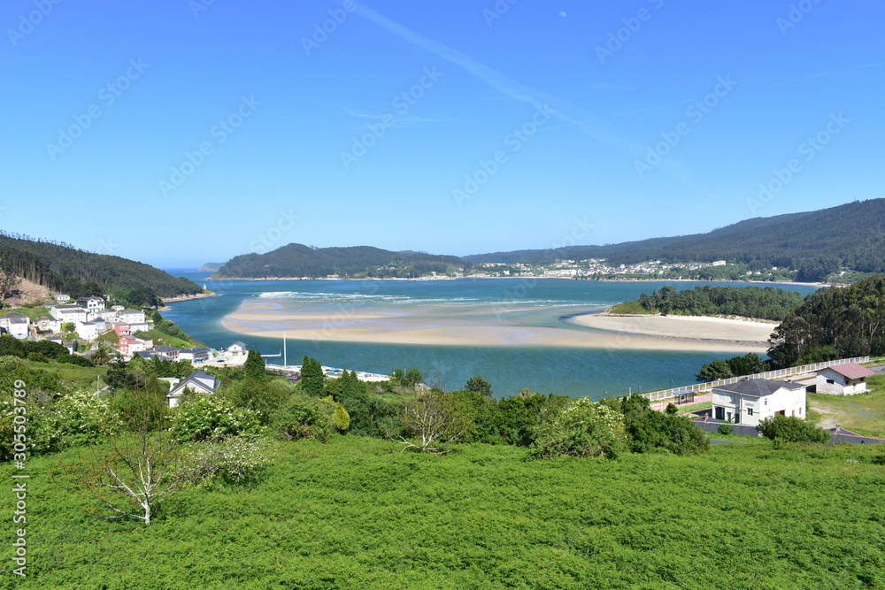 Fototapeta premium Bay with small fishing village and coastal river. O Barqueiro, A Coruña Province, Spain.