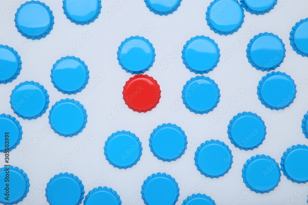 Bottle caps leader on grey background Bottle caps leader on grey background