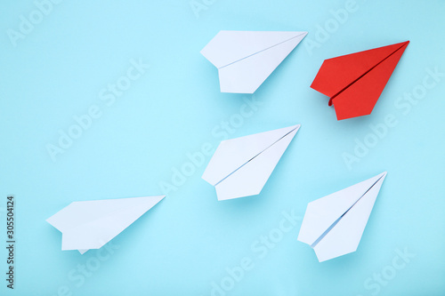 Paper plane leader on blue background