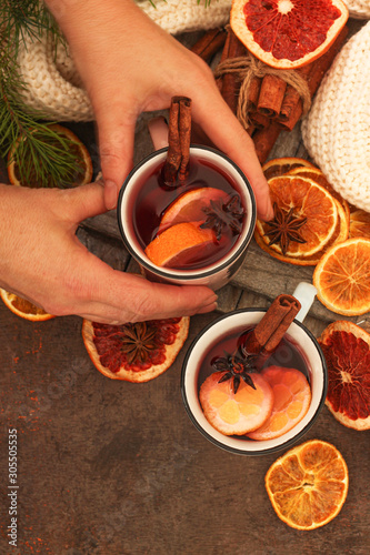 Winter hot tea with oranges and spices for Christmas