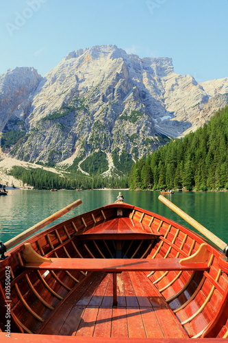 Romantic rowing boat trip on the beautiful Braies lake (lago di Braies) during summertime in the dolomites region, Italy.