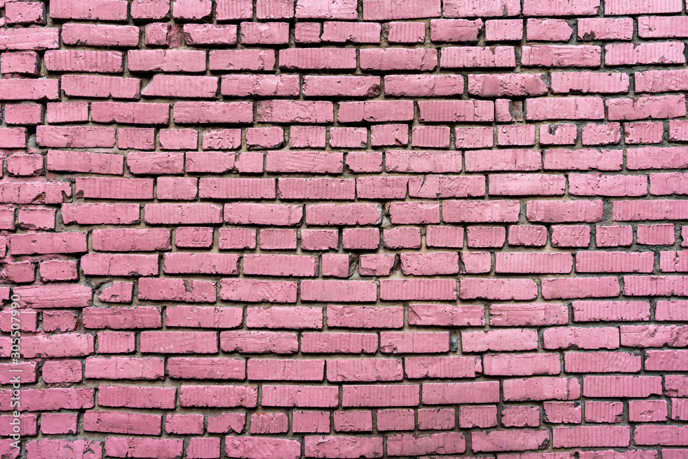 Wall texture of old pink rough brick. Grunge surface background. Vintage brickwall.