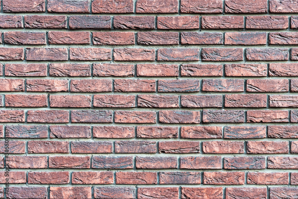 Fototapeta premium Wall texture of old brown rough brick. Grunge surface background. Vintage brickwall.