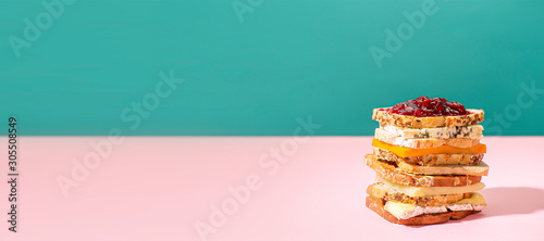 horizontal banner of a Big Sandwich with french cheese toast and  jam on a pink and green background